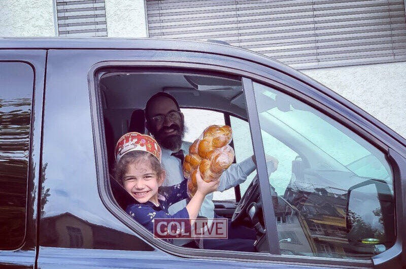 ערב שבת בלוצרן, שוויץ: השליח הרב חיים דרוקמן מחלק יחד עם בתו בת ה-4 חלות לשבת לחברי הקהילה